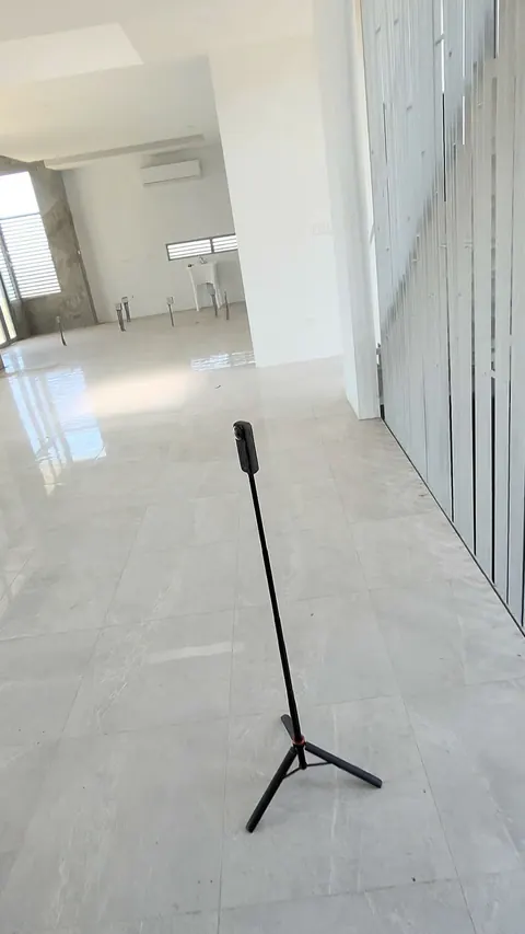 360 camera on a tripod inside an empty house